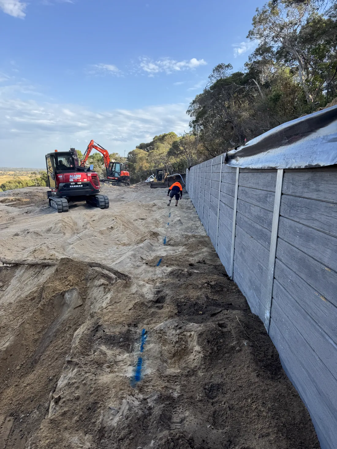 Tall multi-course retaining wall on a large site