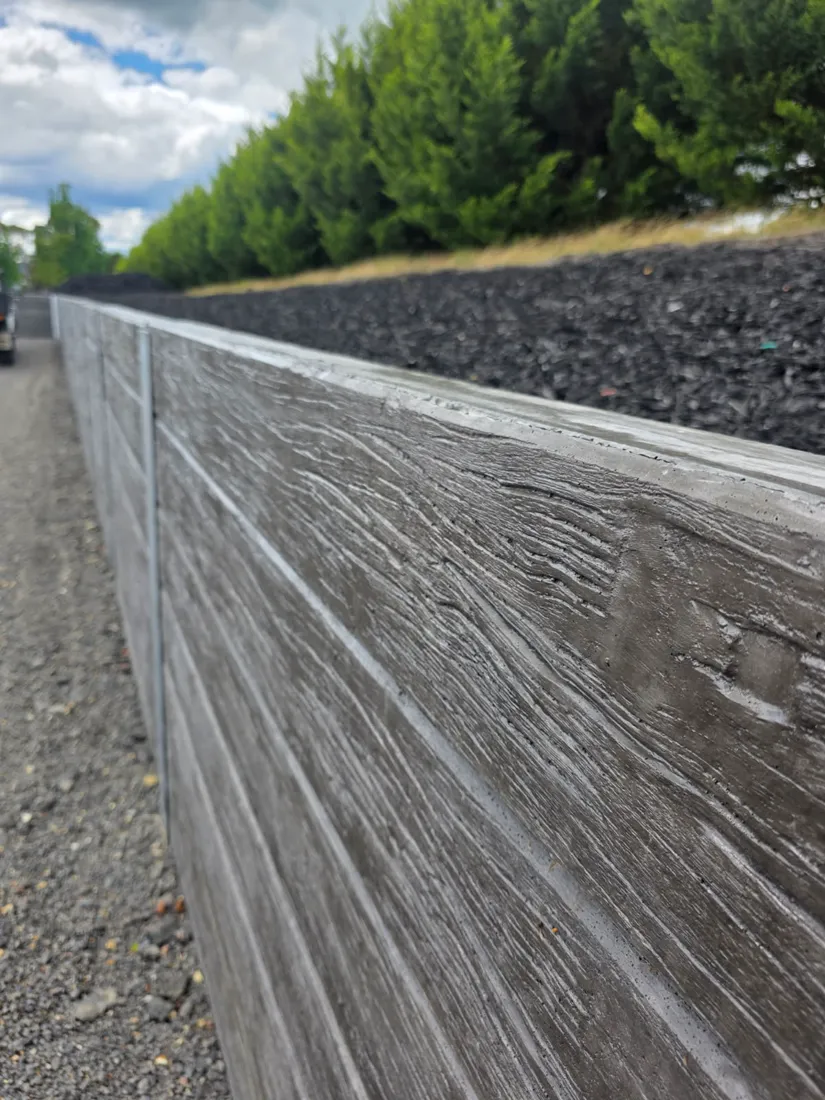 Finished woodgrain sleeper retaining wall